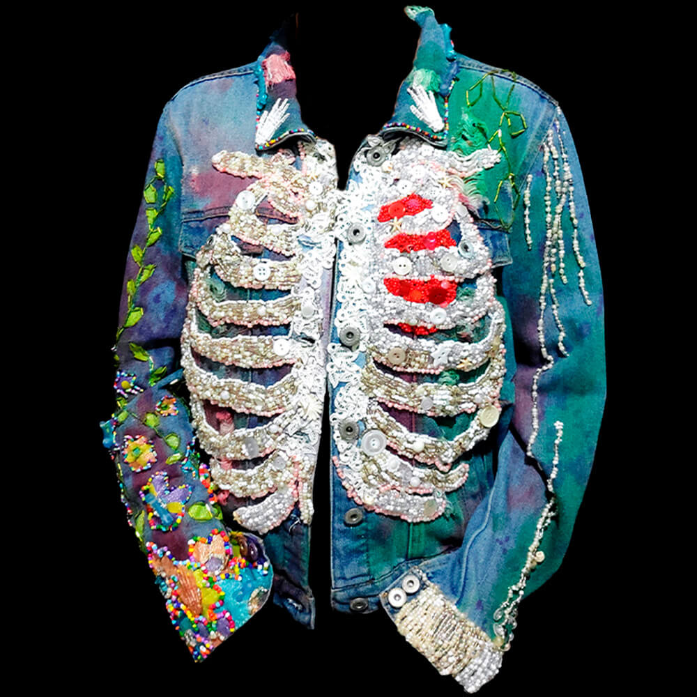 Front view of the "Bones Jacket," showcasing white beaded ribs and a red beaded heart.