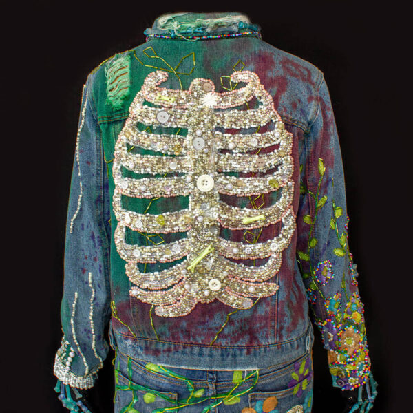 Back view of the beaded ribs in the "Bones Jacket" with green ornaments on the arms of the jacket.