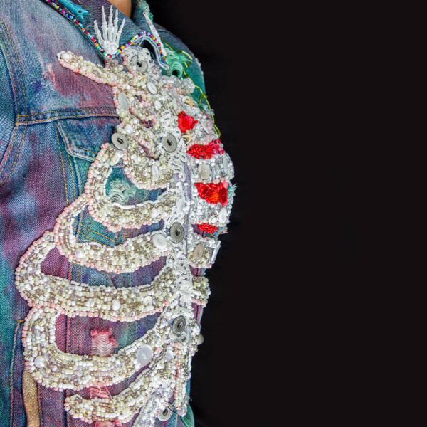 Detail of the right view of the white beaded ribs in the "Bones Jacket."