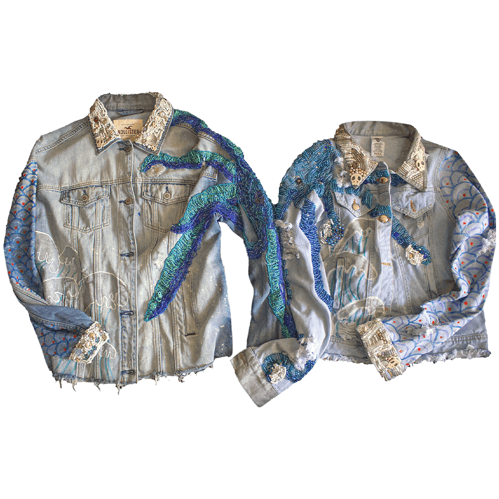 Front view of the 'Pulpis' denim jacket pair, featuring decorative embroidered beaded tentacles in various shades of blue on the shoulders and arms of the jackets. The jackets also showcase decorative embroidery with white beads on the collar and cuffs, along with hand-painted ocean waves