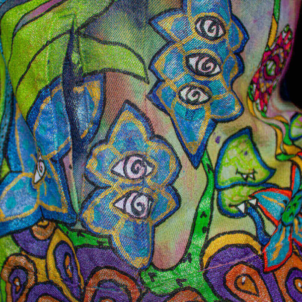 Close-up of the jacket featuring Blue-Eyed Flowers, creatures of the Dua Tua Forest