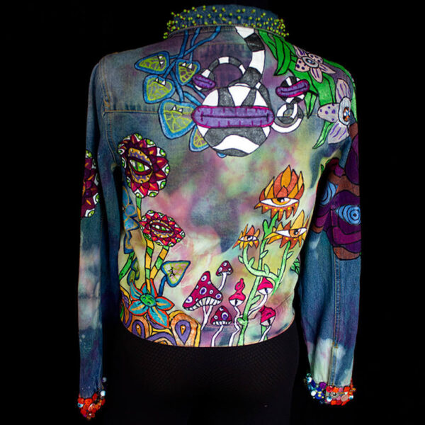 Back view of the Dua Tua's Forest Jacket, adorned with painted creatures and beaded textures on the cuffs and collar