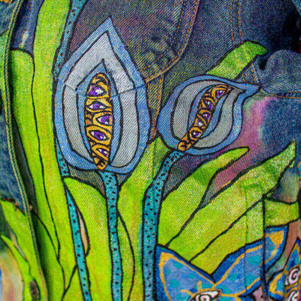 Close-up of the front of the jacket featuring the multiple-eyed blue flowers, creatures of Dua Tua's forest.