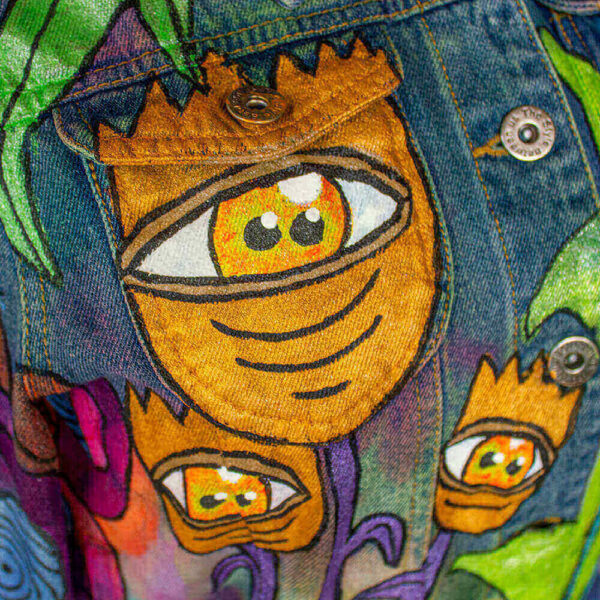 Close-up of the front of the jacket showcasing the one-eyed orange flowers, denizens of Dua Tua's forest concept