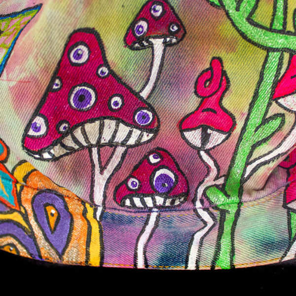 Close-up detail of the bottom back of the jacket featuring red fungi with eyes, another creature that is part of the Dua forest concept