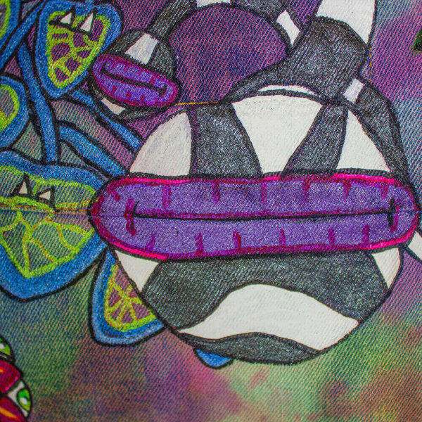 Close-up detail of the back of the jacket featuring a black and white worm with a purple mouth and fang-toothed leaves, creatures that are part of the Dua forest concept