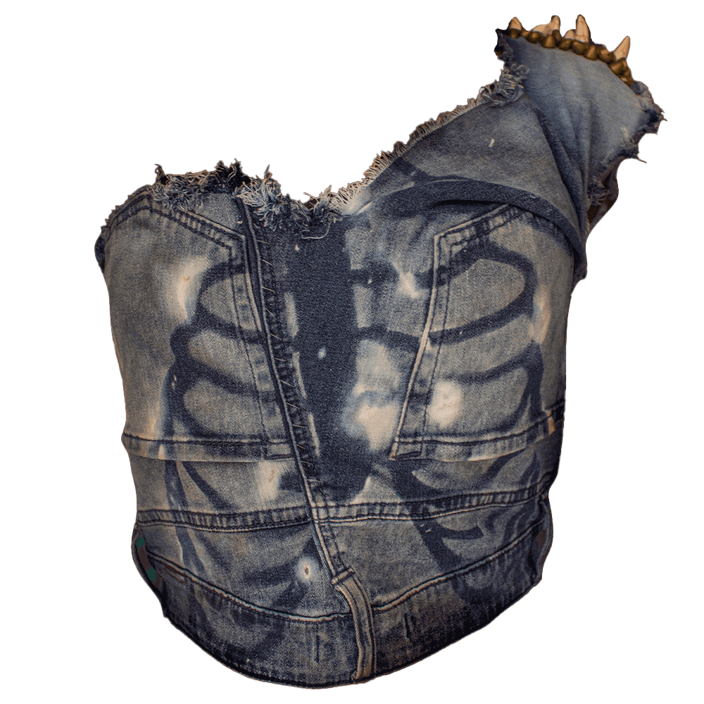 Front view of the Bony Denim Blouse, crafted from recycled denim pants. The front exhibits a ribbed pattern achieved through a bleach tie-dye process. Additionally, the left shoulder features golden brown bead embroidery paired with marble spike rivets intricately attached to the fabric.