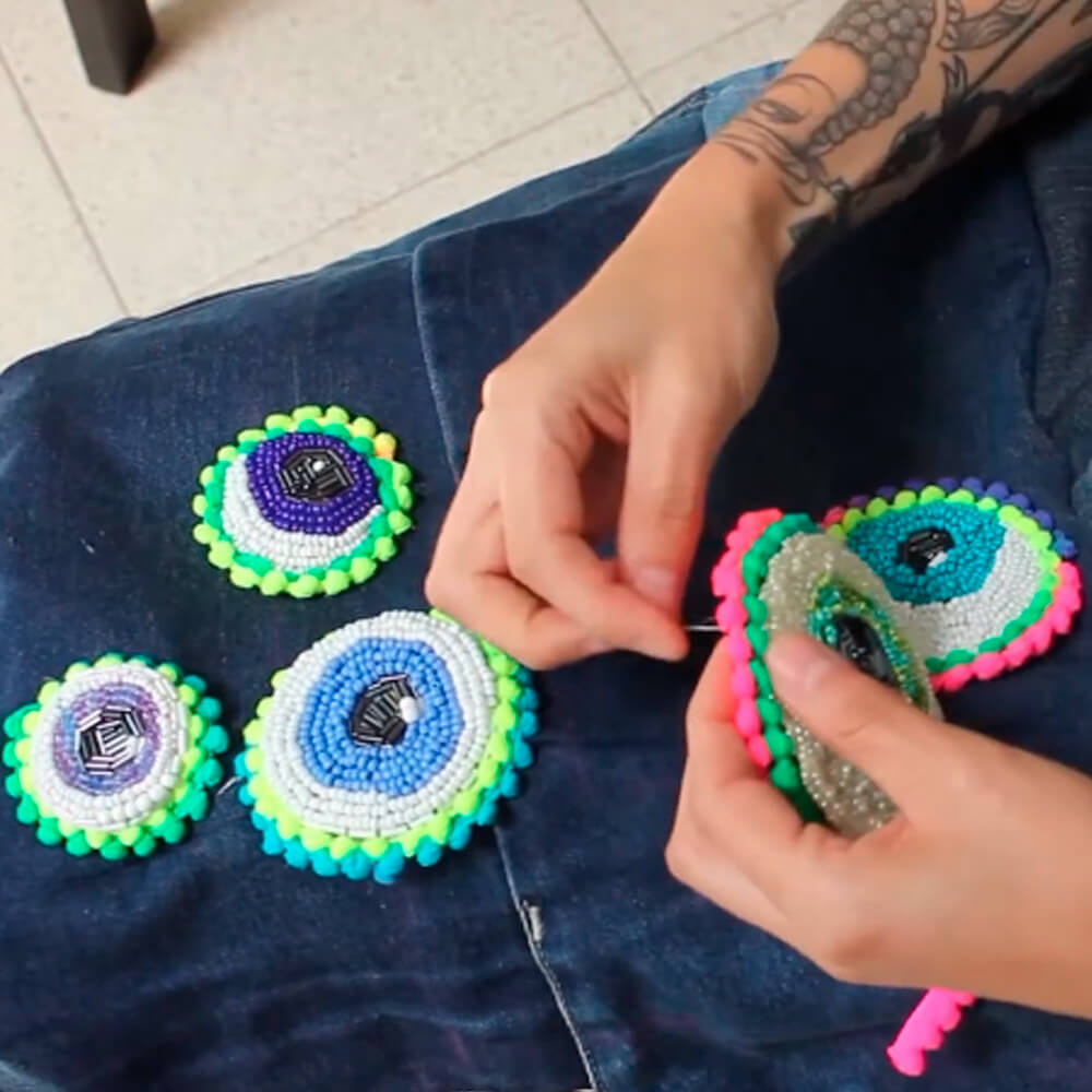 Creation Process of the "I See U Jacket": Dua Tua crafting the eye beaded patches for the jacket.