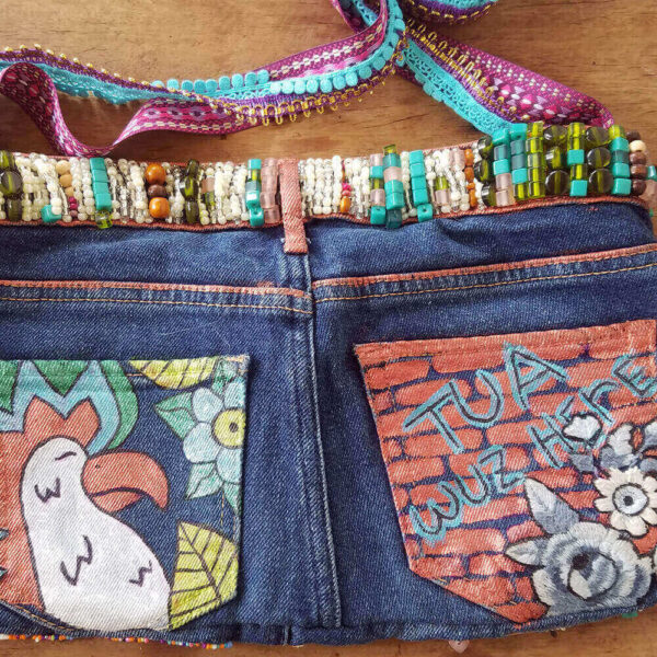 Converting a pair of pants into a purse, close-up detail of the "This Is Art Purse," showcasing painted details.