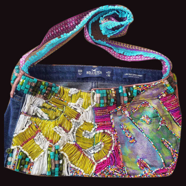 Front view of the "This Is Art Purse," showcasing the beaded texture of the text "This Is Art" with yellow and fuchsia beads.