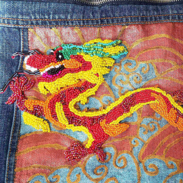 Close-up detail of the beaded dragon patch on the Dragon Purse.