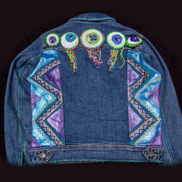 Back view of the "I See You Jacket" showcasing the eye bead patches and a textured pattern of blue and purple metallic colors on the sides of the jacket.