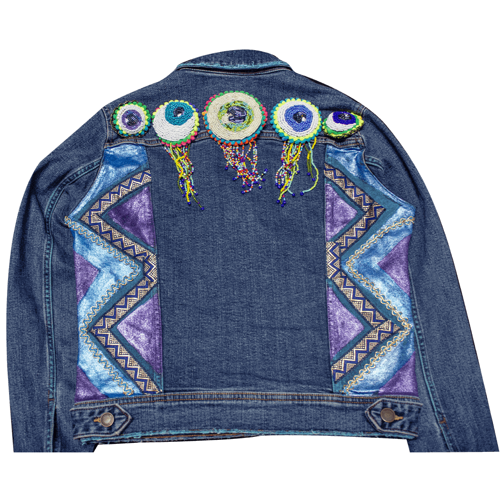 Back view of the "I See You Jacket" showcasing the eye bead patches and a textured pattern of blue and purple metallic colors on the sides of the jacket.