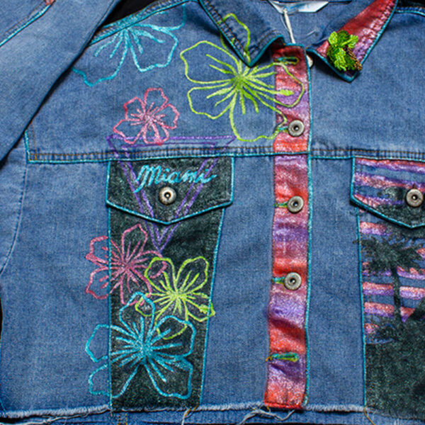 Detail of the front right pocket featuring neon-colored flower drawings on the "Miami Vice" jacket.