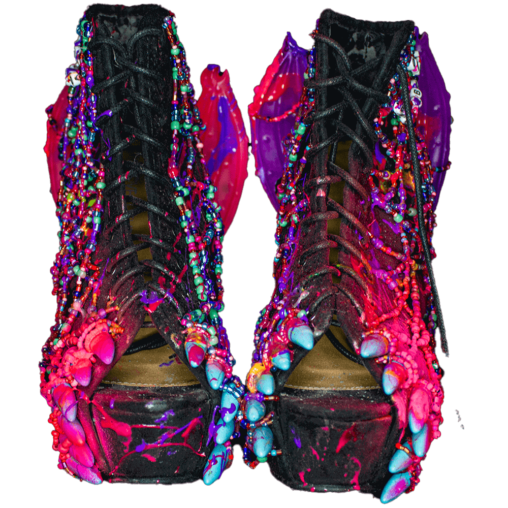 - Front view of the Fuchsia Bats platform heels decorated with spray paint, 3D paint, colorful beads, resin bat wings, and blue fangs accessories