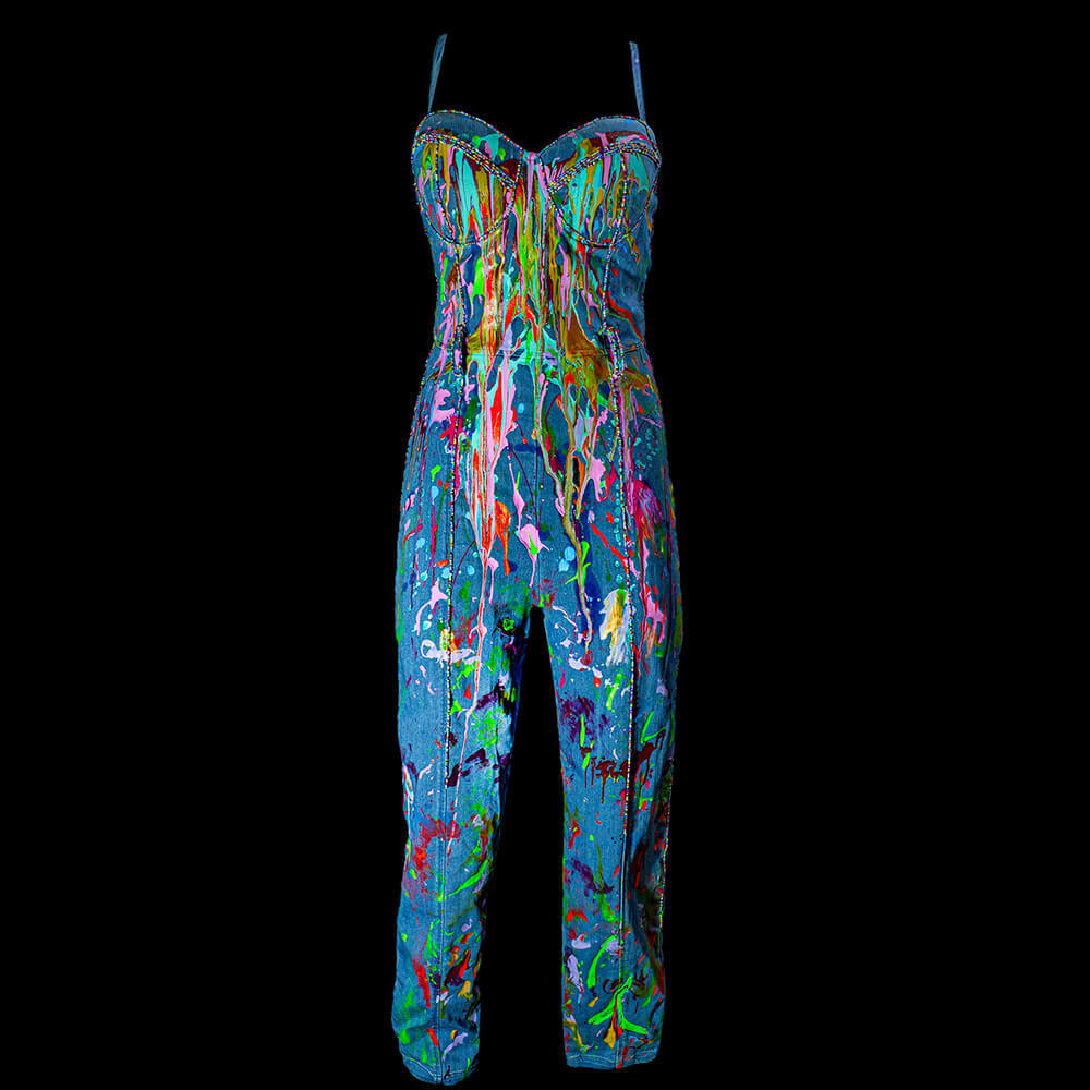 General front view of the Hard Candy denim jumpsuit decorated with fabric paint drippin’ effect and embroidered colorful beads on the strips details