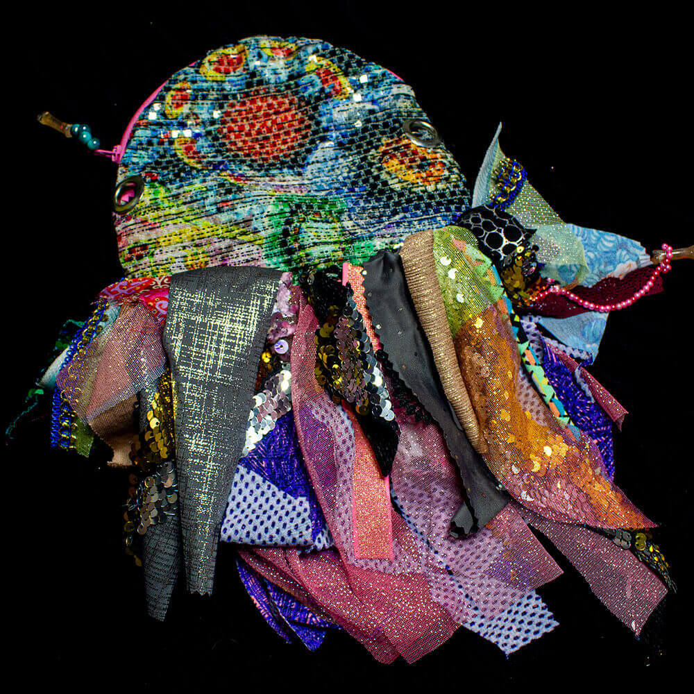 Front view of the Colorful Medusa Purse made from an array of colorful fabrics scraps and sparkling sequins stripes