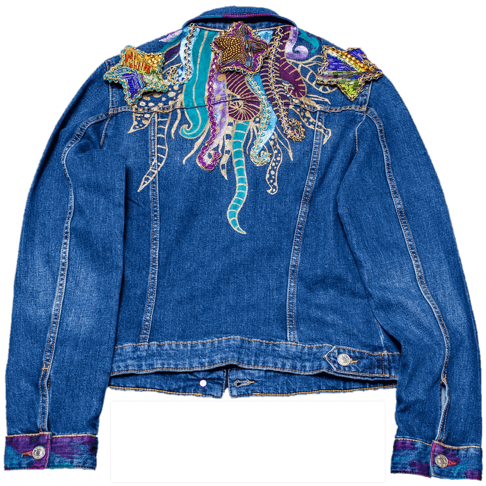 Back view of the Ursula denim jacket customized with metallic painted tentacles, lace details, and fabric paint for the collar color details and 3 removable and beaded star patches