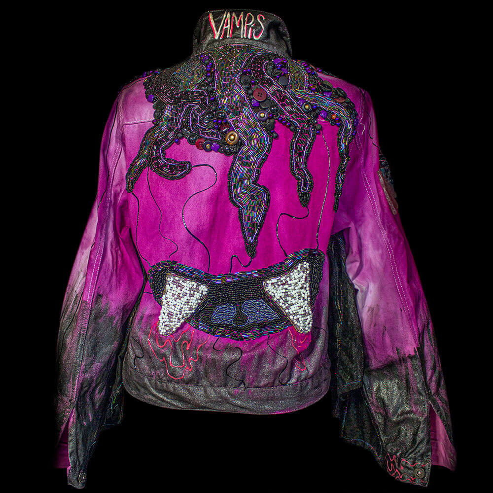 Back view of the Vampis denim jacket decorated with large and rounded beads, fake crystals, tie dye process, fabric paint and 3D paint., removable wings details on the sleeves