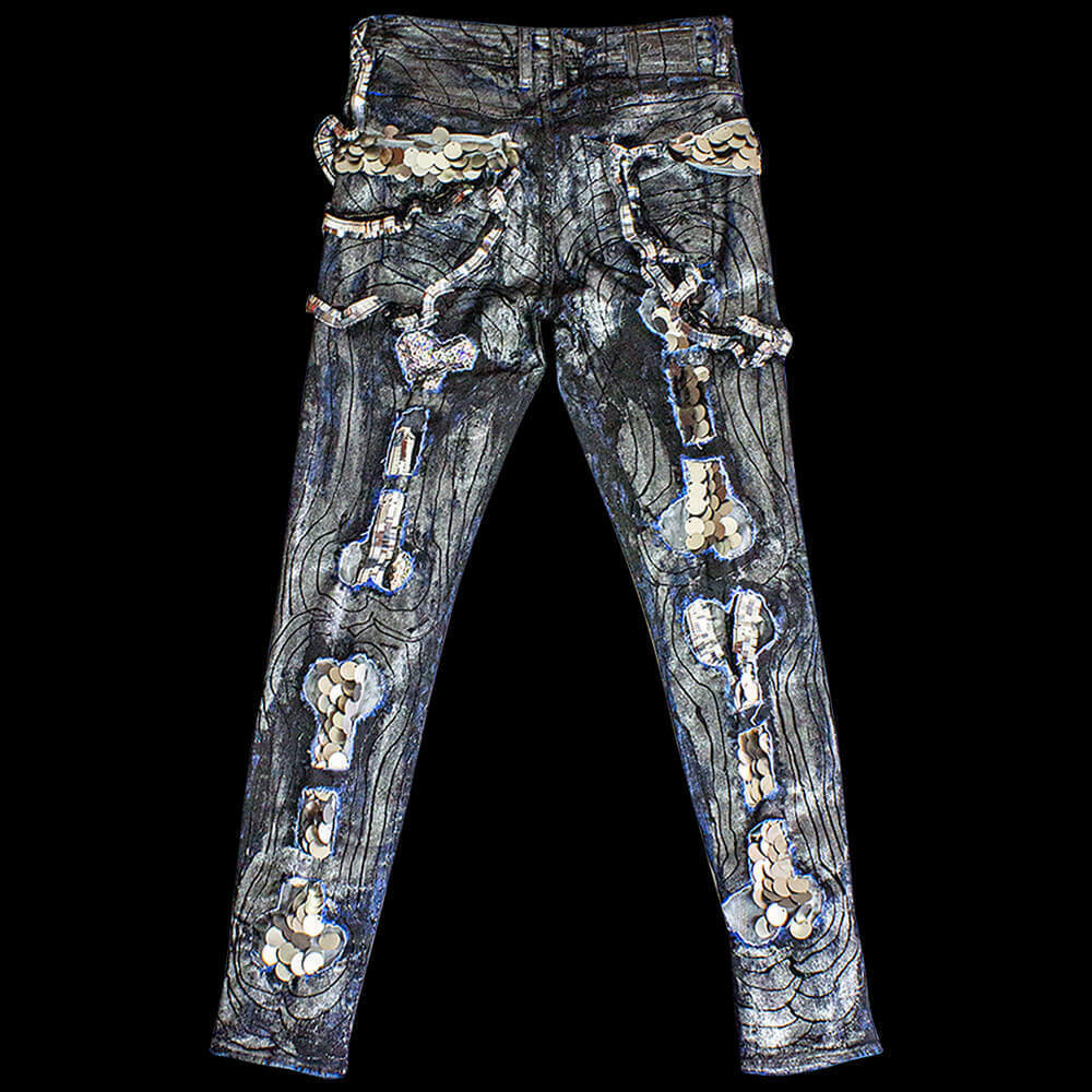 Back view of the White Bones Denim pants featuring hand-made 3D-painted black lines, decorated with silver large and small sequin bone patterns, and painted with silver paint