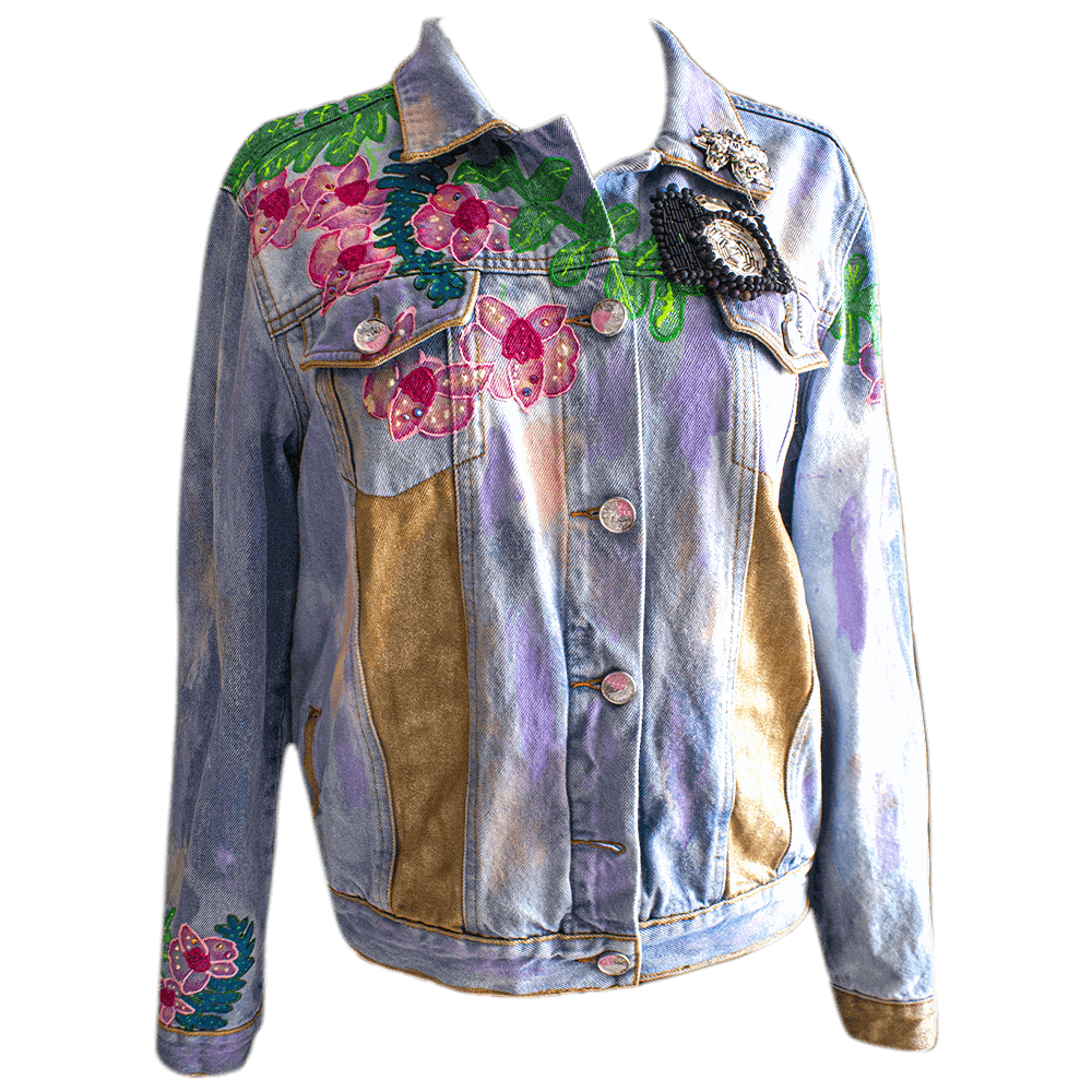 General front view of the denim Jacket for Alba, decorated with a removable handmade camera-shape beaded removable patch, fabric paint and 3D paint for the flowers details